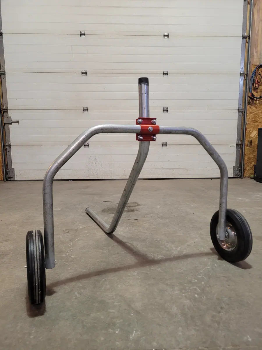 Two-wheel sprinkler cart, front view, against the shop door